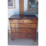 A Georgian mahogany chest with two short over three long drawers, with brass handles and oak lined