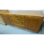 An Ercol Sideboard with two cupboard and three drawers, 156cm wide x 69cm high