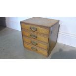 A small oak bank of four drawers - 31cm tall x 30cm x 25cm