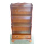 A small very attractive mahogany bookcase with a lower drawer, mounted on bracket feet - 113cm H x