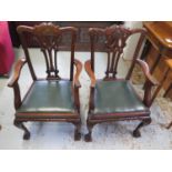 A pair of Georgian style mahogany desk armchairs on shaped legs and ball and claw feet