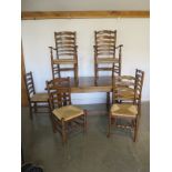 A good quality oak refectory table and six ladder back dining chairs, including two carvers, in very