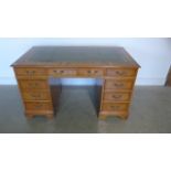 A yew effect nine drawer twin pedestal desk - 77cm tall x 137 x 76cm