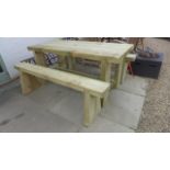 A heavy duty wooden garden table and two matching benches - W180cm x D80cm