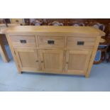 A Sussex oak three drawer sideboard 150cm W x 44cm D x 91cm H