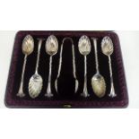 A cased set of six plated teaspoons and sugar tongs, in a decorative shell form, in good condition