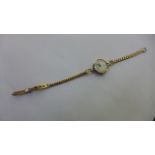 A ladies Rolex 9ct gold precision manual wind wristwatch on a 9ct strap, total weight approx 17