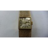 A 9ct gold ladies Tissot wristwatch with 9ct gold bracelet and case, approx 25.8 grams, currently