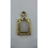 A gold mounted pendant -tests as 18ct gold- with rectangular pearlescent central section, approx 4.