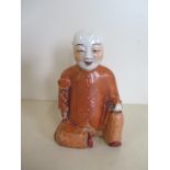 A Chinese porcelain lamp-base depicting a youthful god of longevity, height 16cm - minor glaze