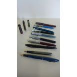 A collection of various fountain pens, including two with 14ct gold nibs, a Sheaffer and a