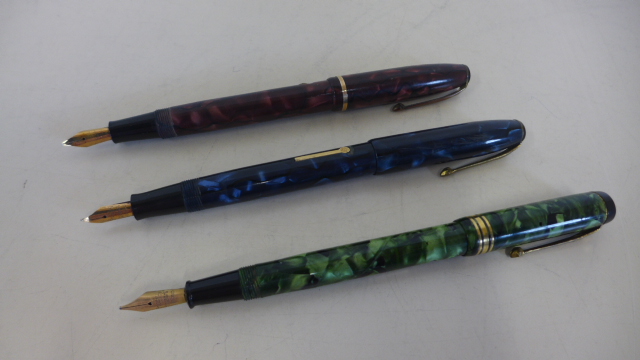 Three Conway Stewart fountain pens with 14ct gold nibs, of different designs, cases in good