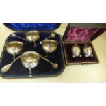 A set of four silver salts by Henry Wigful, Sheffield 1923, with four associated salt spoons,