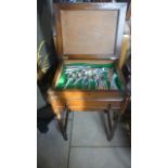 An oak cutlery stand and Viners cutlery set of eighteen places and a half set of four and six fish