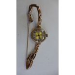 A 9ct yellow gold ladies manual wind wristwatch on a 9ct spring strap - running total weight