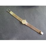 A ladies 9ct gold manual wind bracelet wristwatch 20mm wide including winder, 18cm long, approx