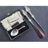 A silver pusher and spoon, and a silver handle button hook and shoe horn - weighable silver approx