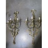 A pair of brass three branch wall lights - 84cm high