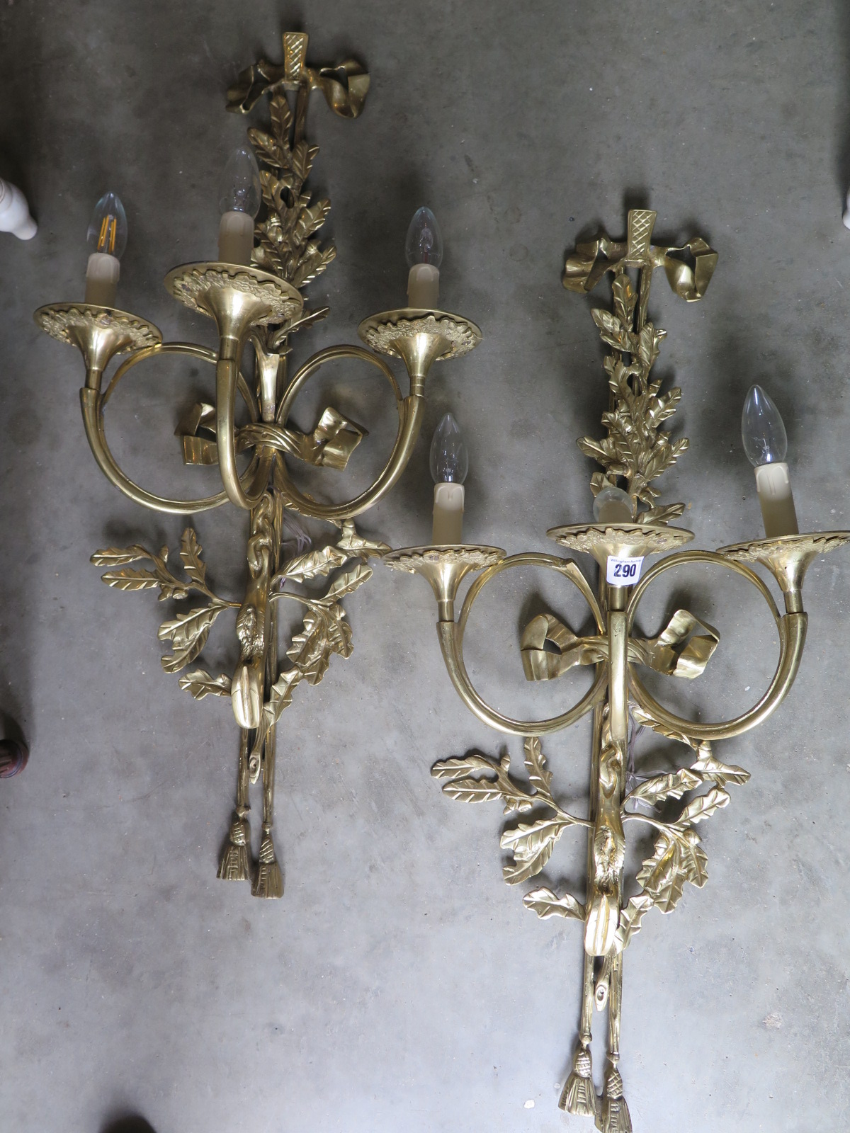 A pair of brass three branch wall lights - 84cm high