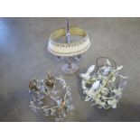 Two small hanging chandeliers and a table light