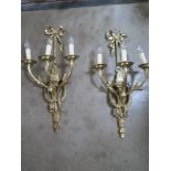 A pair of good quality brass three branch wall lights, 68cm high