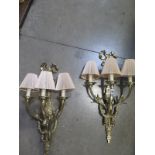 A pair of good quality brass three branch wall lights, 68cm high