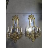 A pair of good quality ornate four branch wall lights with mirror backs 68cm high