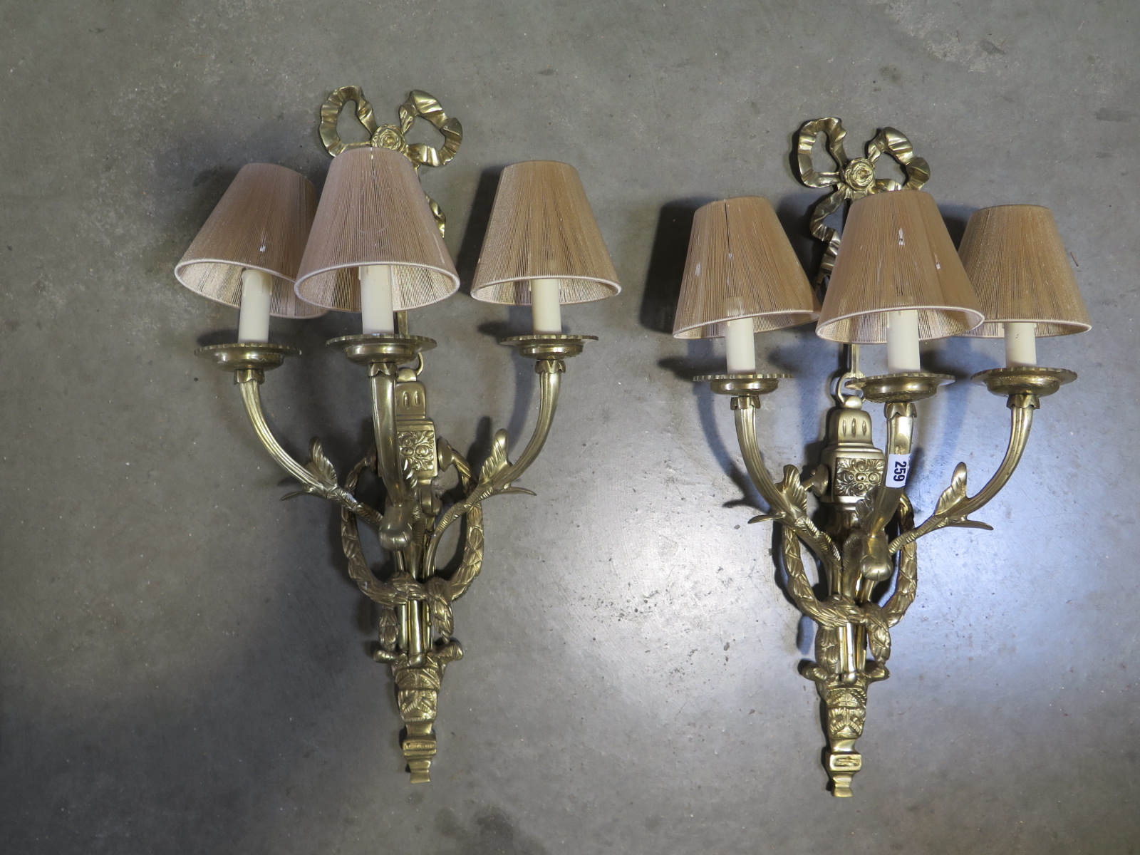 A pair of good quality brass three branch wall lights, 68cm high