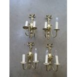 A set of four brass two branch wall lights - 35cm high