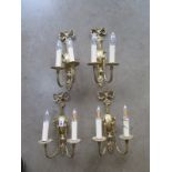 A set of four brass two branch wall lights - 35cm high