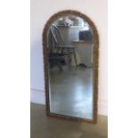 A gilt-framed bevel edge mirror with arched top - 90cm x 45cm