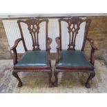 A pair of Georgian style mahogany desk chairs on shaped legs and ball and claw feet
