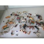 A collection of white metal and plastic moulded toy farm and zoo animals, with some Britains