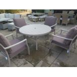 A Bramblecrest casual dining and four chairs with cushions, in powder coated aluminium, scratches to