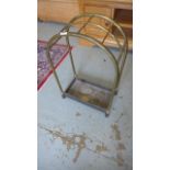 A brass and iron stick stand with an arched top