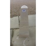 A hand carved limestone obelisk, with the eye of Horus carved on one side, approx 51.5cm H