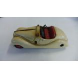 A Schuco Examico 4001 tin plate clockwork sportscar, approx 14.5cm long in a play worn condition