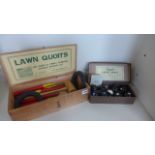 A lawn quoits garden game with box and a set of Banda carpet bowls in a box