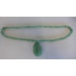 A light green jade pendant necklace, approx 64cm long, pendant 5.5cm, in generally good condition,