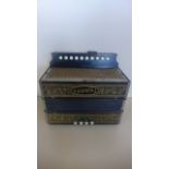 A Vintage Hohner accordion with four brass and ten buttons in playable condition with replacement