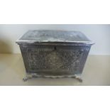 A silver plated tea caddy with fine eastern style decorated panels raised upon four feet, approx