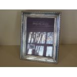 A silver photo frame 22x17cm - boxed, in good condition