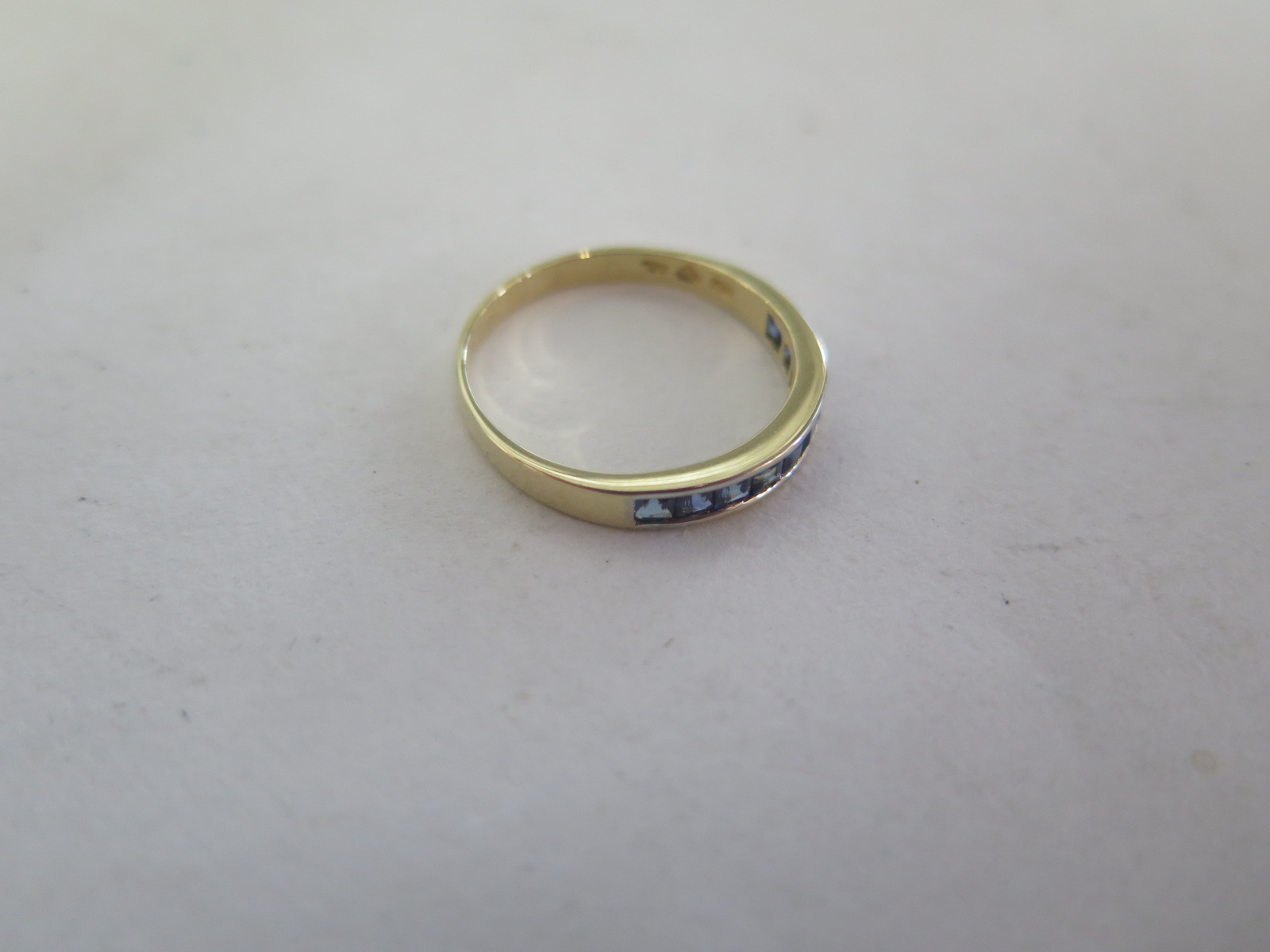 An 18ct yellow gold band ring, set with nine sapphires, ring size Q, approx 2.2 grams, in good - Image 2 of 3