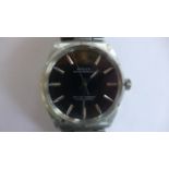 A gents Rolex Oyster Perpetual automatic wristwatch with black dial and stainless steel bracelet