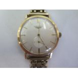 A 9ct gold gentlemens manual wind wristwatch, with baton markers, and subsidiary dial, case approx