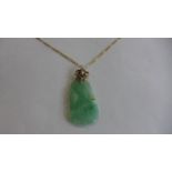 A jade pendant on a 9ct gold chain, pendant approx 5cm long, necklace approx 60cm long, chain approx