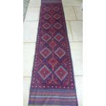 A hand knotted woollen Meshwani runner - 253cm x 61cm - in good condition