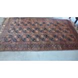 A Persian hand knotted faded redish field rug - 350cm x 187cm