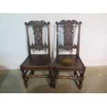 A pair of 18th century carved oak chairs, with solid seats, 100cm tall