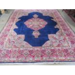 A hand knotted woollen Kirman rug, 357cm x 276cm